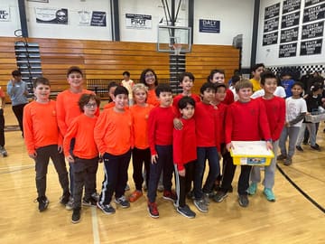 A school robotics team gathered in the gym