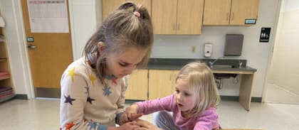 Two campers building a LEGO robot together at an UP Robotics summer camp