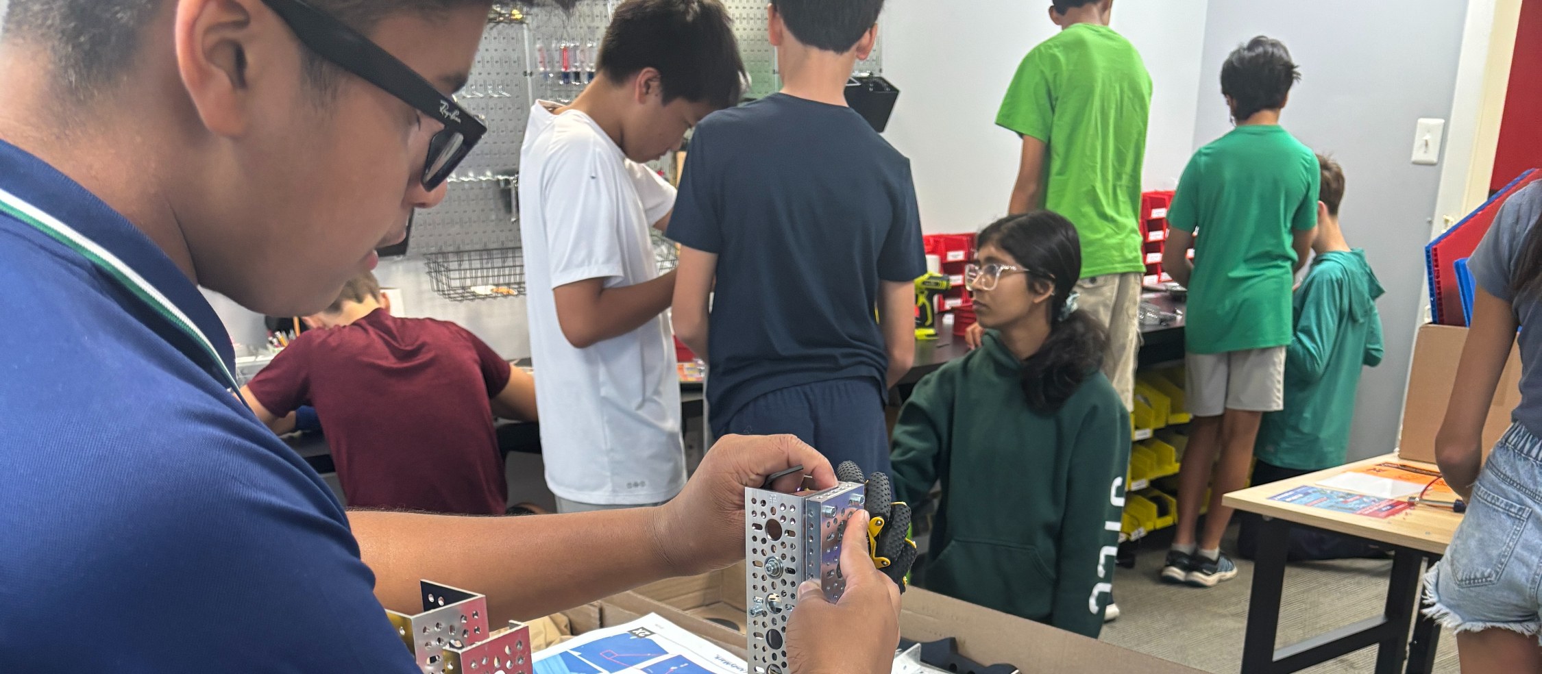 Students building and testing robots together in an UP Robotics class
