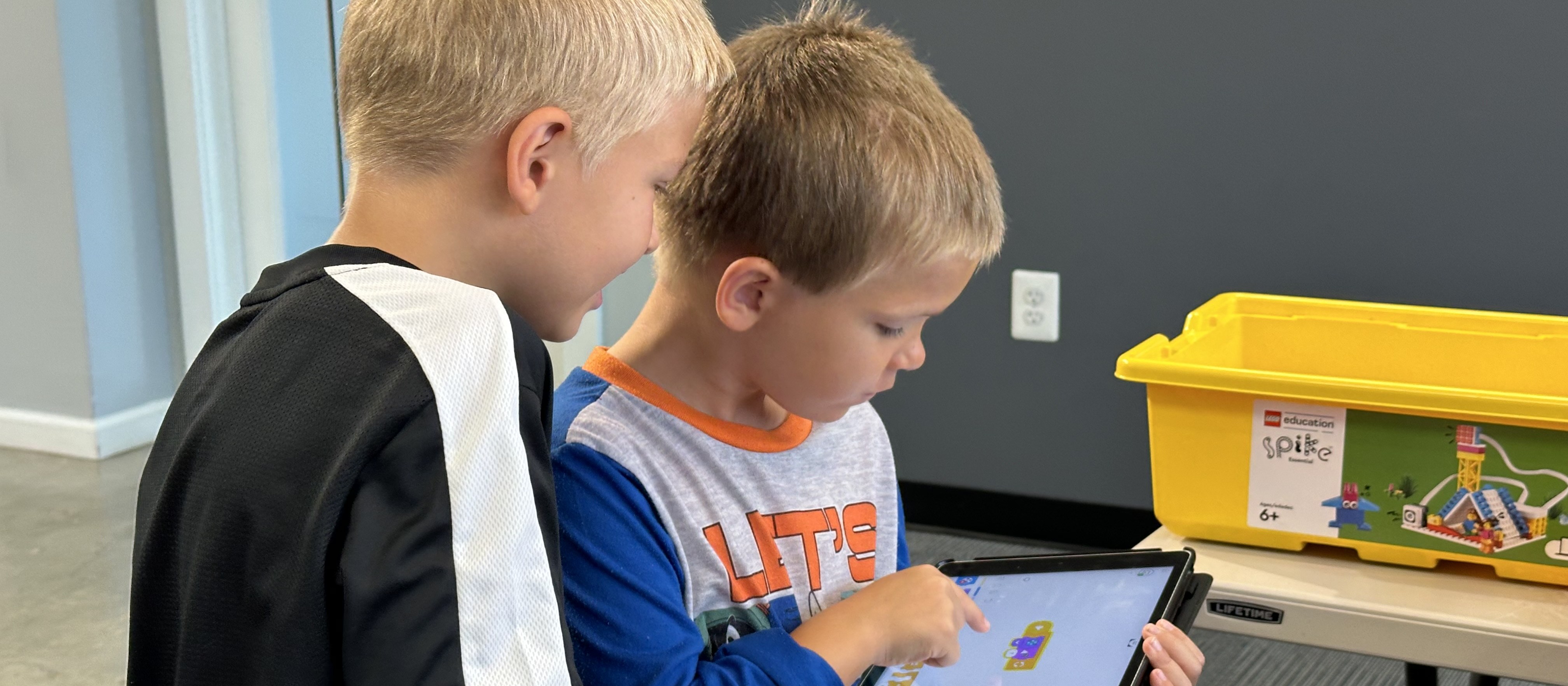 Two students working together on a tablet during an UP Robotics class